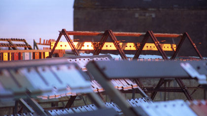 film still: Dexion glow: This image was taken about twenty minutes after sunrise, when the light of the sun is at its most acute angle. The strength and direction of the warm light has really pushed &amp; emphasized the residual colours of the old &amp; not so old metal construction.

