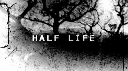film still: *Half Life* title card. A misaligned Super 8mm splice creates a sandwich of dust around the celluloid, partially obscuring the cold winter sunshine (North Wales)

