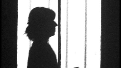 film still: Ms Szminka  (Fiona Staniland) collates and files Mr Marker’s data

