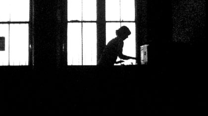 film still: Ms Szminka  collates and files Mr Marker’s data

