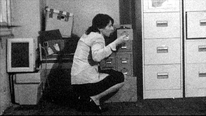 film still: Ms Szminka checks up on her little secret

