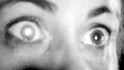 film still: In a moment of passion / panic Fraulein Stromkreis triggers an alarm

