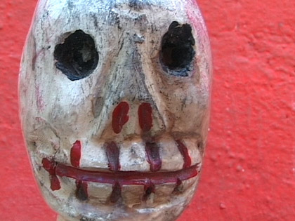 film still: Hooked skull on red


